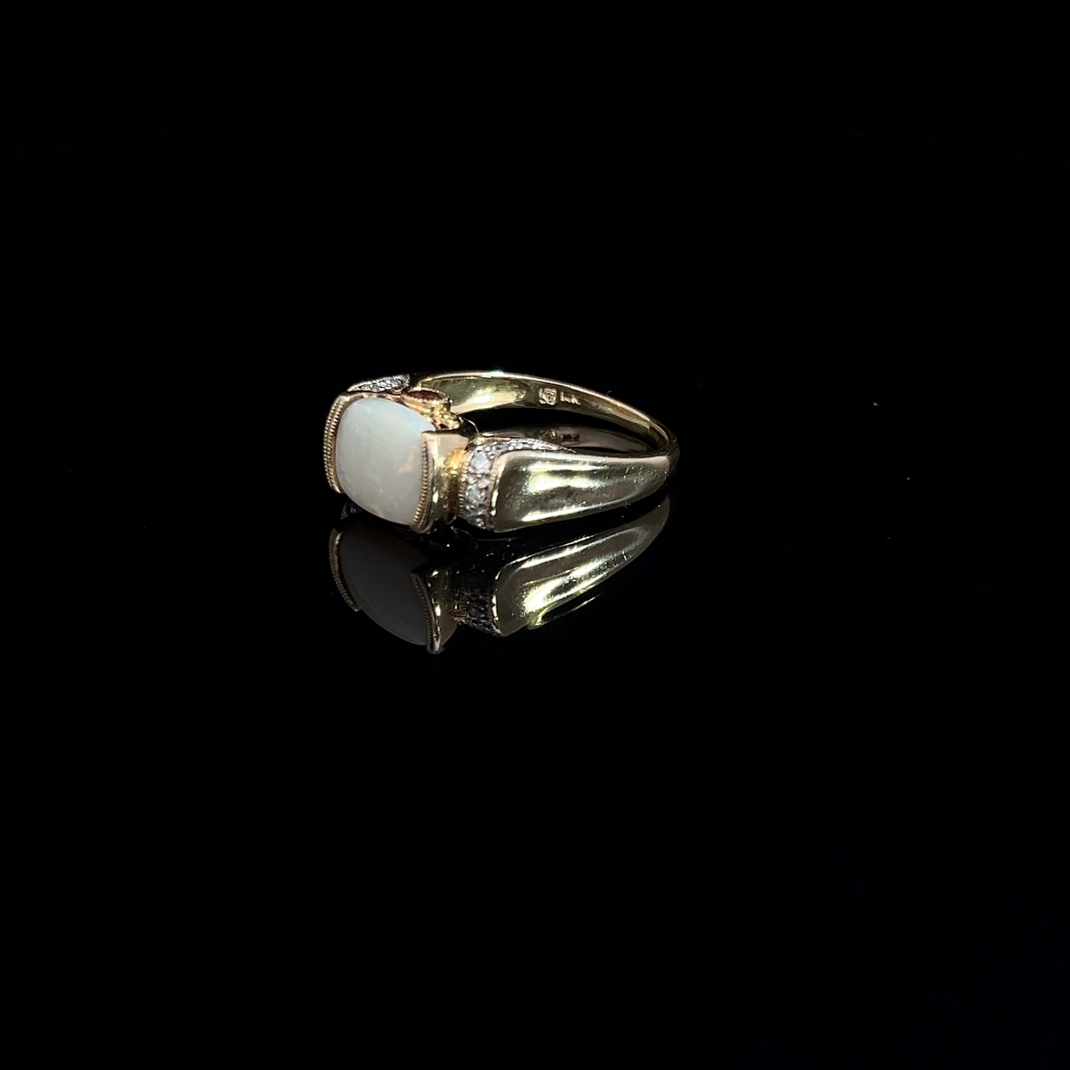14k Yellow Gold 2.00ct Oval Opal/ .12ct Round Diamond and .10ct Round Rhodolite Garnet Ring