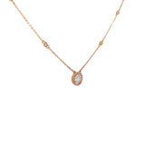 Ladies 14k rose gold diamond solitaire necklace with diamond halo.