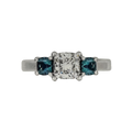 PLATINUM 1.08CT F VS1 CUSHION SET IN A PAST, PRESENT AND FUTURE MOUNTING WITH TWO ROUND LABORATORY GROWN ALEXANDRITES CERTIFIED BY GIA #5234160482 FOR CUSHION  AND GIA #2231160642 FOR ROUND ALEXANDRITES