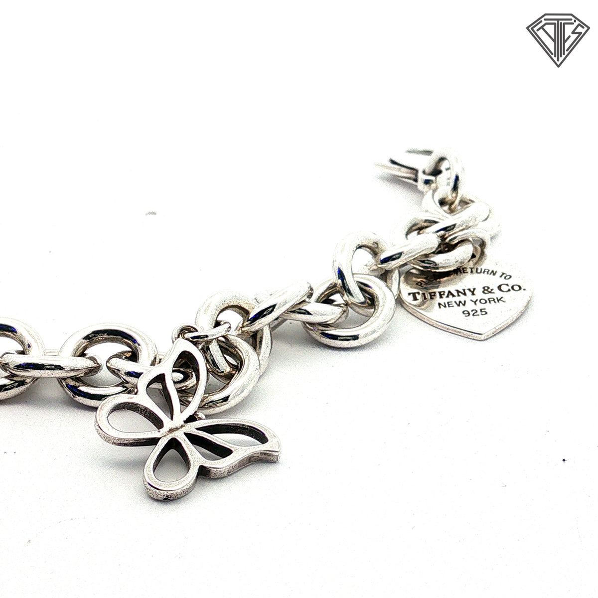 Pre-Loved Tiffany & Co. Sterling Silver Return to Tiffany Heart Tag Charm Bracelet with Butterfly Charm, Beaded Heart "Mom" Charm, Letter E Pad Lock, Peace Sign, Heart Pad Lock Charm Bracelet 61.7 gram  7.5 inch