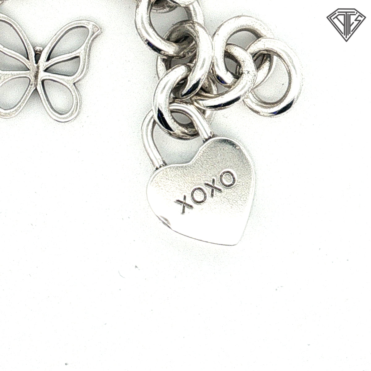 Pre-Loved Tiffany & Co. Sterling Silver Return to Tiffany Heart Tag Charm Bracelet with Butterfly Charm, Beaded Heart "Mom" Charm, Letter E Pad Lock, Peace Sign, Heart Pad Lock Charm Bracelet 61.7 gram  7.5 inch