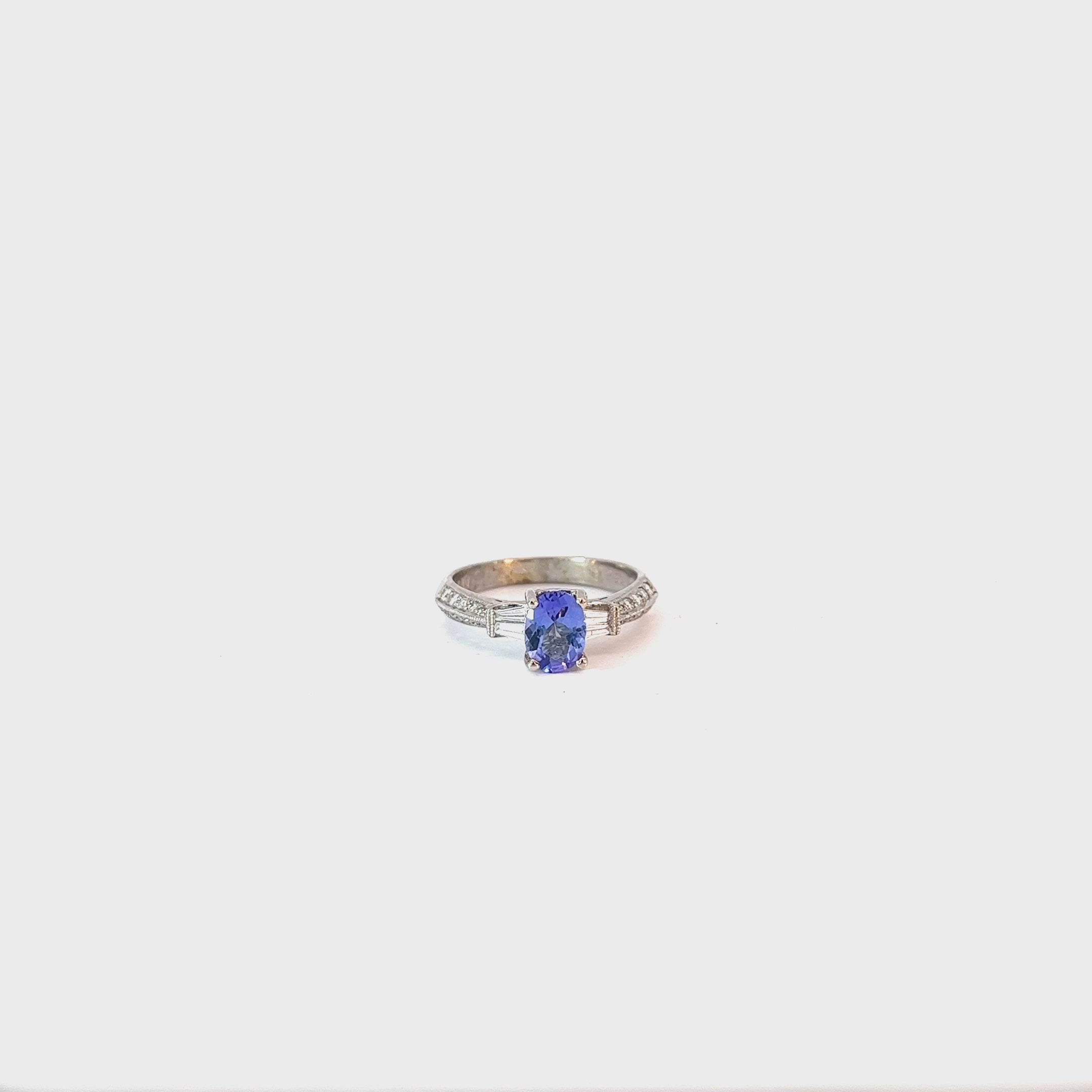 14k White Gold .75ct Oval Tanzanite and surround by .34ct F VS2 Round and Baguette Total Weight Diamond  Ring
