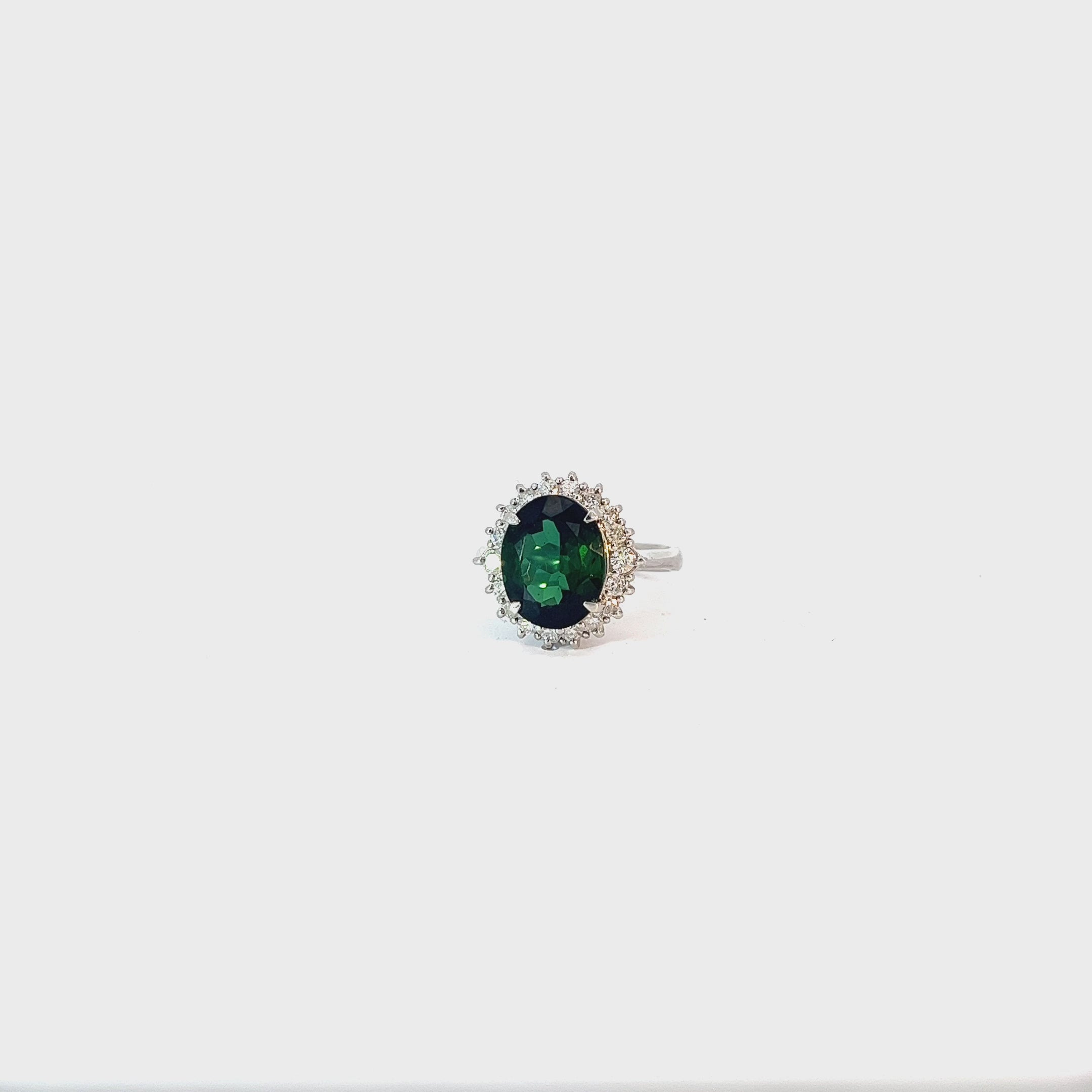 Platinum 4.04ct Oval  AAA Green Tourmaline and surround by the halo .50ct G SI1 Round Diamond ring