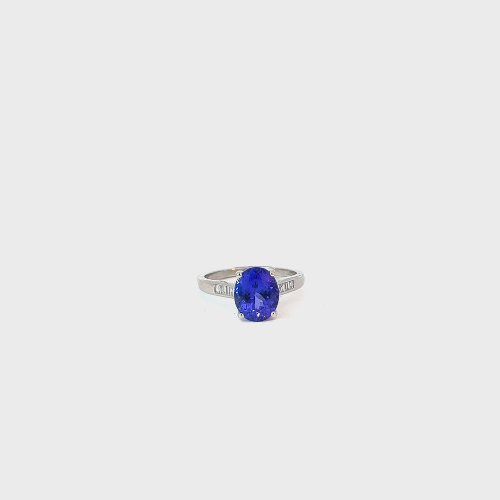 Platinum 3.50ct Oval Shaped AAA Tanzanite and Surround by .30ct F VS2 Baguette Diamond Ring