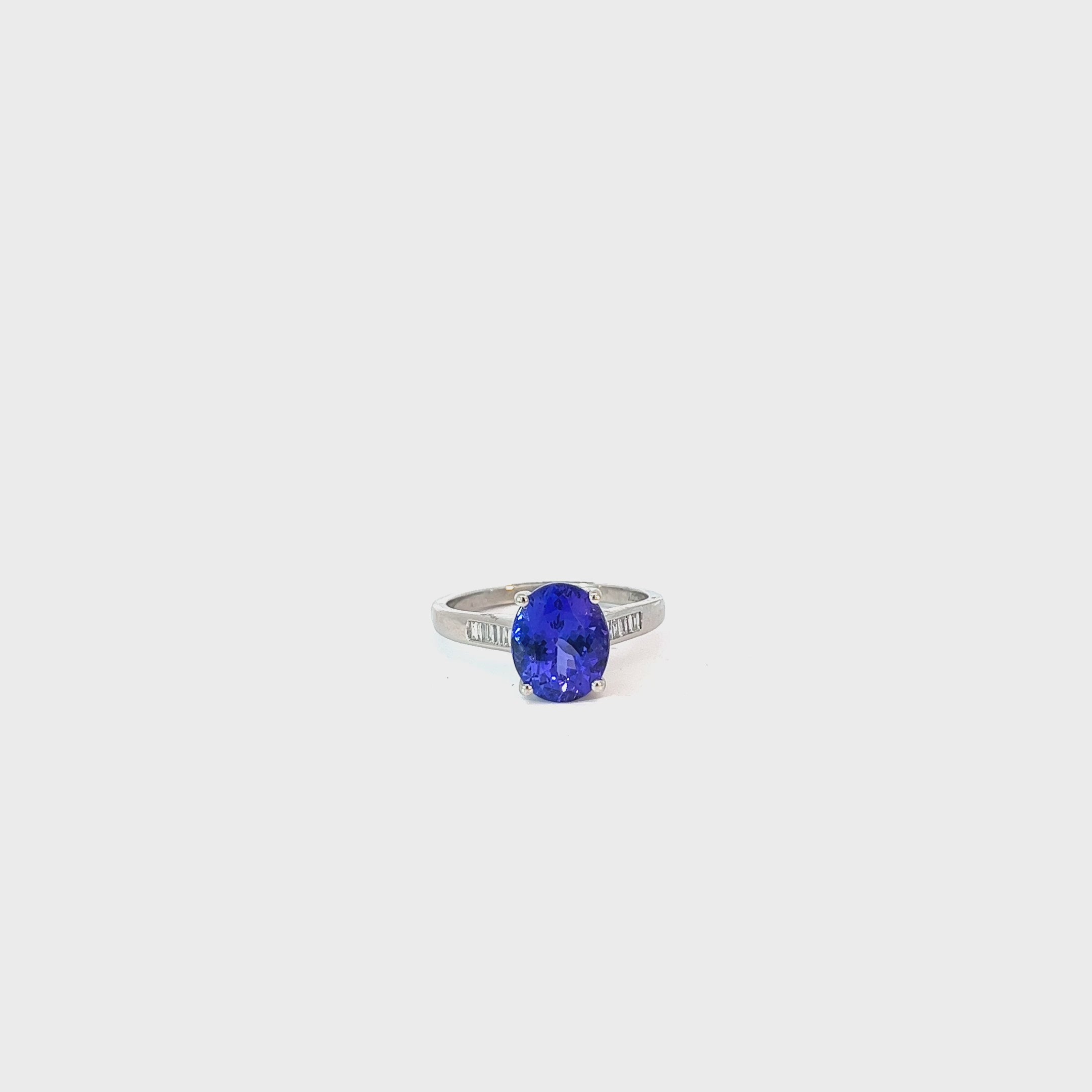 Platinum 3.50ct Oval Shaped AAA Tanzanite and Surround by .30ct F VS2 Baguette Diamond Ring