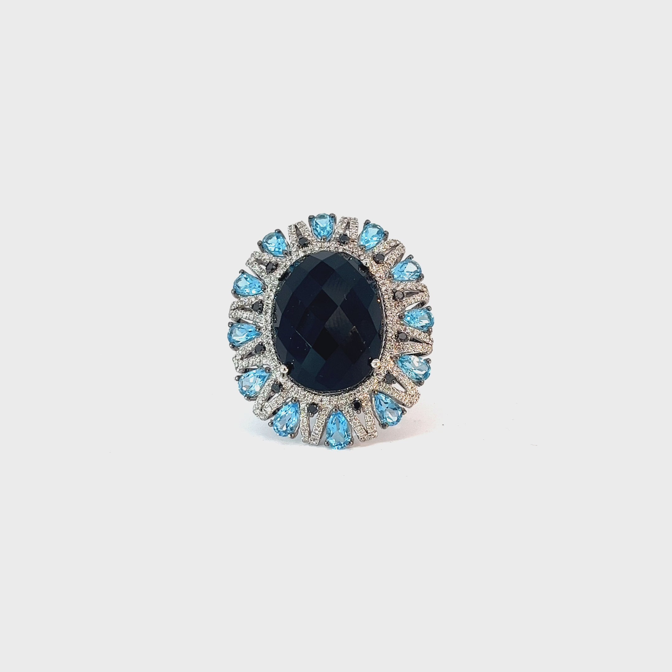 18k White Gold 18.00ct Oval shaped Onyx/ 3.00ct Pear Shaped Blue Topaz and .75ct G VS1 Round Diamond Ring